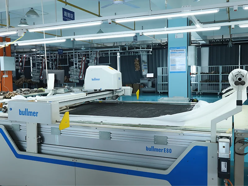 Automated Bullmer fabric cutting machine in WHFrontend’s production workshop, improving precision and efficiency in outdoor apparel manufacturing.
