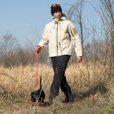 Outdoor model wearing khaki waterproof jacket for men, ideal for hiking, trekking, and all-weather adventures.