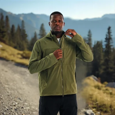 Outdoor model wearing green waterproof jacket for men, ideal for hiking, trekking, and mountain adventures.