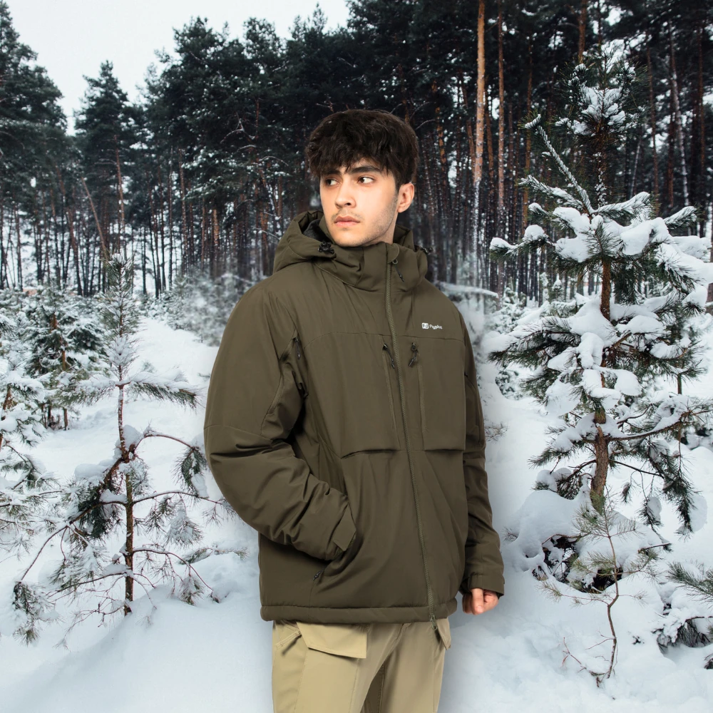 Model wearing waterproof winter jacket in snowy forest, designed for hiking, trekking, and cold climate protection.