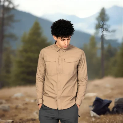 Model wearing khaki hiking shirt in forest background, showing natural and durable outdoor performance.