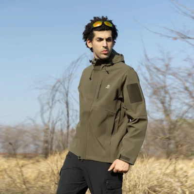 Olive green waterproof jacket for men photographed outdoors, featuring windproof and breathable design for hiking, camping, and tactical outdoor use.