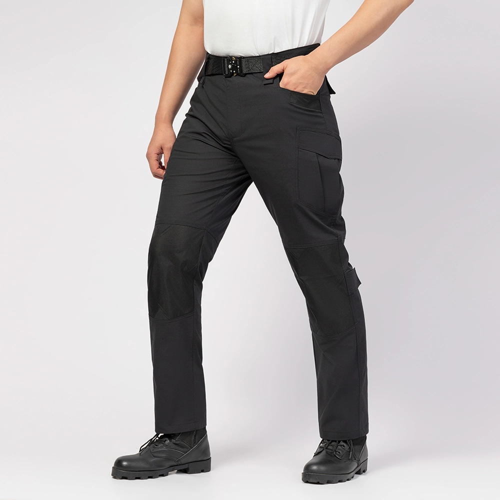 Model wearing black waterproof hiking pants, demonstrating ergonomic design, elastic waist, and reinforced knee protection for hiking and work.